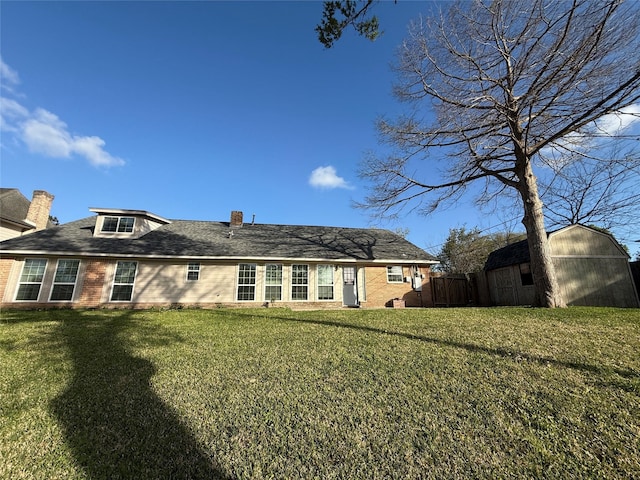 301 Old Bayou Dr, Dickinson, TX 77539 - rear view of house with brick siding, a storage unit, a chimney, and roof with shingles