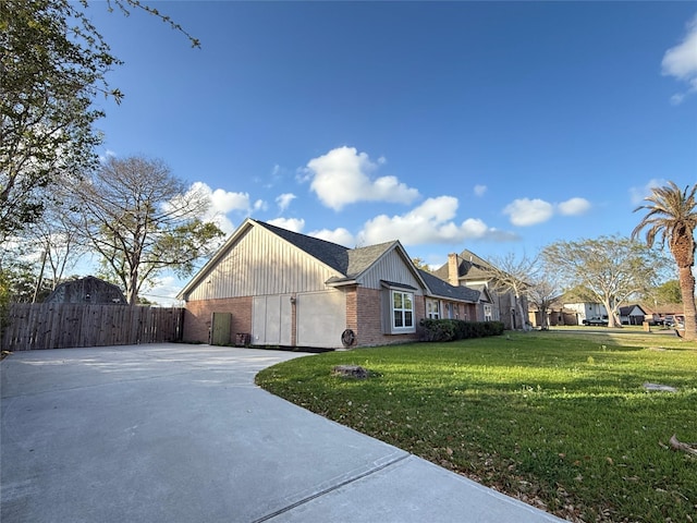 301 Old Bayou Dr, Dickinson, TX 77539 - view of property exterior with concrete driveway, an attached garage, brick siding, and board and batten siding