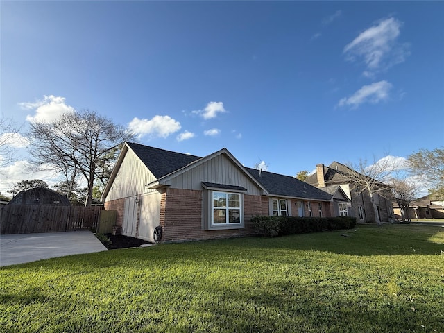 301 Old Bayou Dr, Dickinson, TX 77539 - view of side of property with brick siding, a shingled roof, and a gate