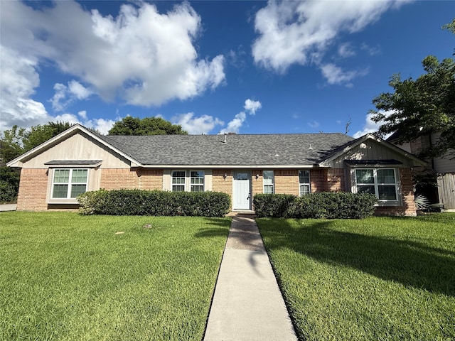301 Old Bayou Dr, Dickinson, TX 77539 - ranch-style home featuring brick siding, a front lawn, and roof with shingles