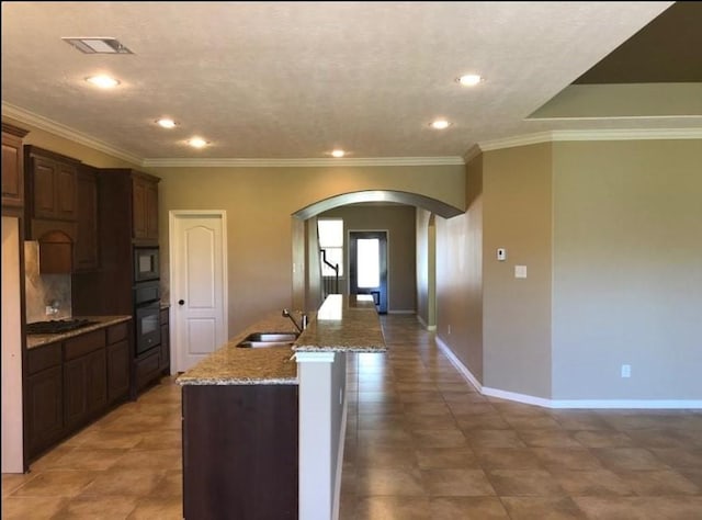 6110 Watford Bnd, Rosenberg, TX 77471 - kitchen featuring arched walkways, a sink, gas stovetop, oven, and recessed lighting
