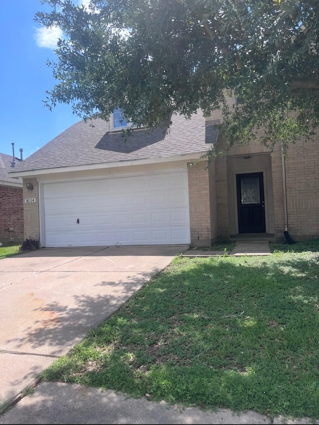 8114 Golden Trace Ct, Houston, TX 77083 - view of front of house with brick siding, driveway, a front lawn, and roof with shingles