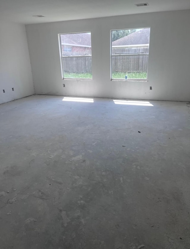 8114 Golden Trace Ct, Houston, TX 77083 - empty room with unfinished concrete flooring and healthy amount of natural light