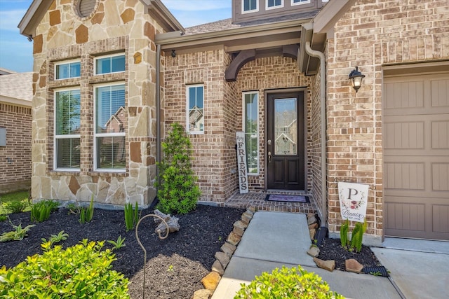 1861 Kenley Way, Alvin, TX 77511 - view of exterior entry featuring brick siding, stone siding, and roof with shingles