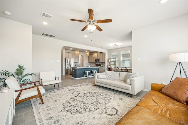 1861 Kenley Way, Alvin, TX 77511 - tiled living room with arched walkways, a ceiling fan, recessed lighting, and a sink