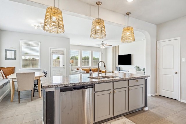1861 Kenley Way, Alvin, TX 77511 - kitchen with dishwasher, a sink, open floor plan, light tile patterned floors, and light stone counters