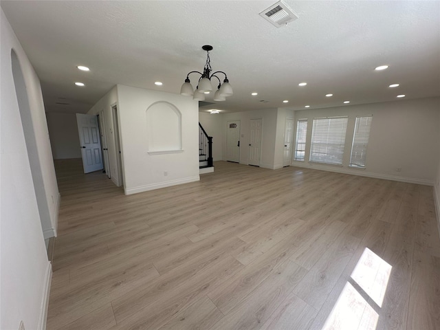 21207 Rushing Creek Ln, Katy, TX 77449 - unfurnished living room with stairs, recessed lighting, baseboards, light wood-type flooring, and a chandelier