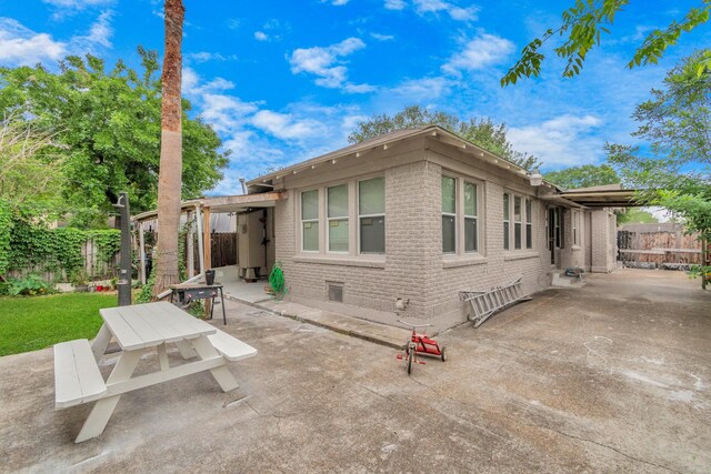 8209 Howard Dr, Houston, TX 77017 - back of house featuring brick siding and a patio area