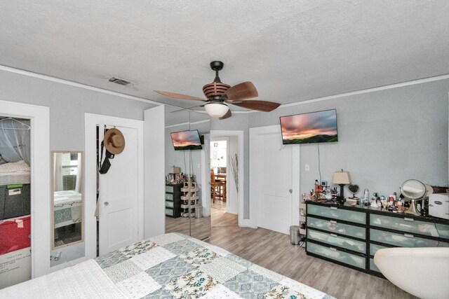 8209 Howard Dr, Houston, TX 77017 - bedroom with wood finished floors, ornamental molding, a textured ceiling, and a ceiling fan