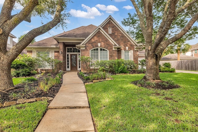 1930 Crisfield Dr, Sugar Land, TX 77479 - traditional-style house featuring brick siding and a shingled roof