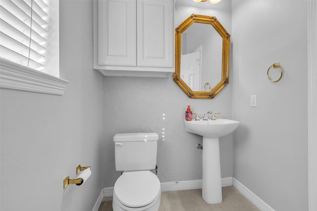 1930 Crisfield Dr, Sugar Land, TX 77479 - half bath featuring toilet, baseboards, a sink, and tile patterned floors