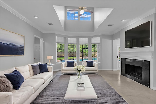1930 Crisfield Dr, Sugar Land, TX 77479 - living room featuring ceiling fan, crown molding, a fireplace, a tray ceiling, and baseboards