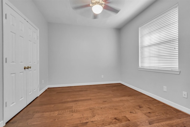1930 Crisfield Dr, Sugar Land, TX 77479 - unfurnished bedroom featuring wood finished floors, baseboards, a ceiling fan, and a closet