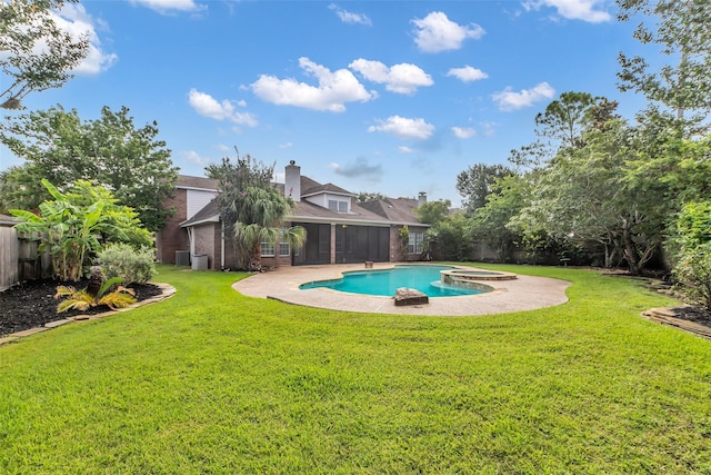 1930 Crisfield Dr, Sugar Land, TX 77479 - view of pool with a sunroom, a patio area, a pool with connected hot tub, and central AC