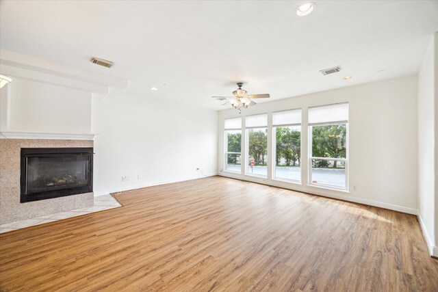 2402 Calumet St Unit C, Houston, TX 77004 - unfurnished living room featuring a ceiling fan, wood finished floors, a fireplace with flush hearth, baseboards, and recessed lighting