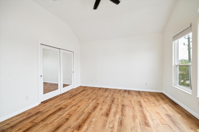 2402 Calumet St Unit C, Houston, TX 77004 - unfurnished bedroom with lofted ceiling, multiple windows, light wood-style floors, baseboards, and ceiling fan