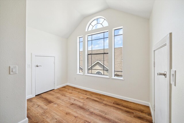 2402 Calumet St Unit C, Houston, TX 77004 - empty room featuring vaulted ceiling, wood finished floors, and baseboards