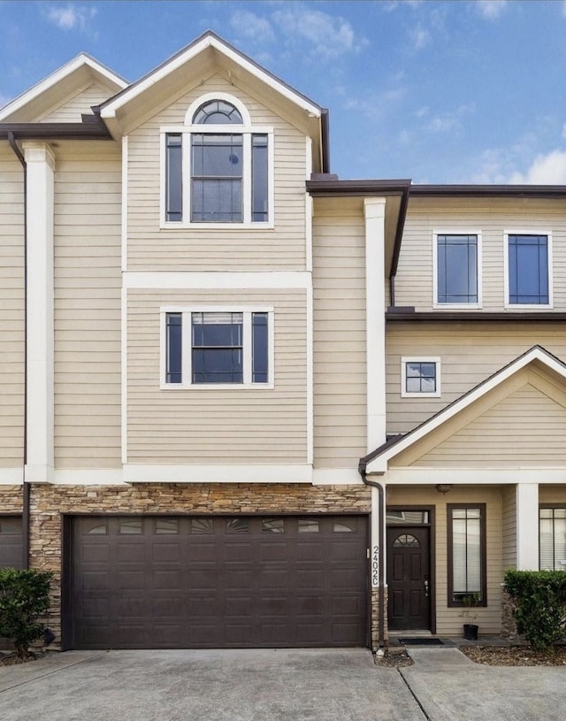 2402 Calumet St Unit C, Houston, TX 77004 - townhome / multi-family property with an attached garage, driveway, and stone siding