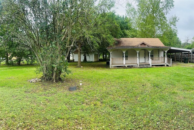 6115 Jade Ave, Port Arthur, TX 77640 - view of front of house featuring a porch, a front lawn, and a carport