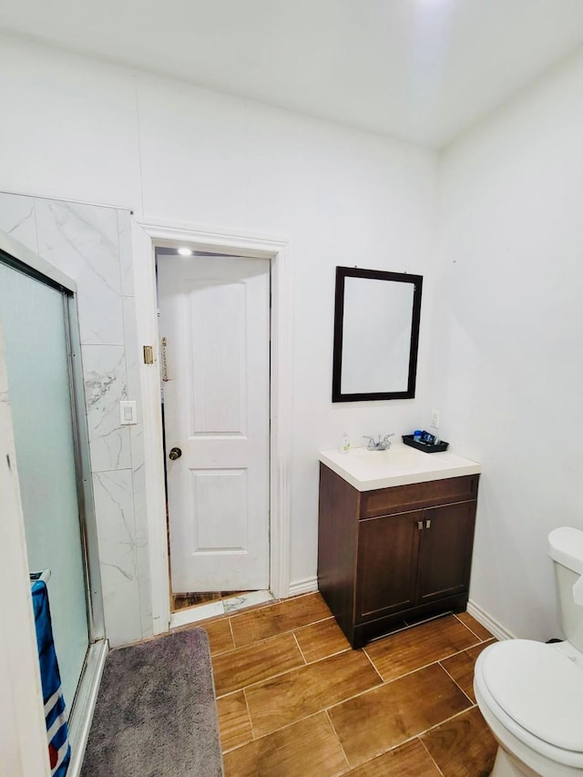6115 Jade Ave, Port Arthur, TX 77640 - full bath with vanity, toilet, a stall shower, baseboards, and wood tiled floors