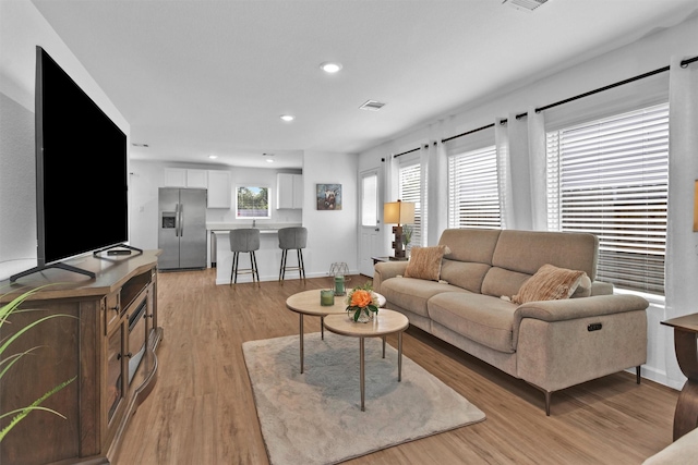 317 Riverwood Village Ln, Sealy, TX 77474 - living room featuring light wood-type flooring, recessed lighting, and baseboards
