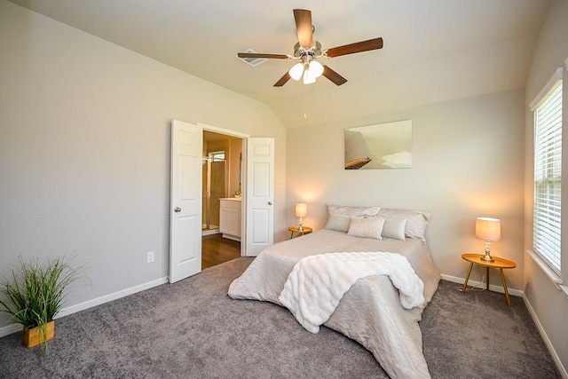10130 Barn Owl Trl, Magnolia, TX 77354 - bedroom with dark carpet, baseboards, vaulted ceiling, connected bathroom, and a ceiling fan