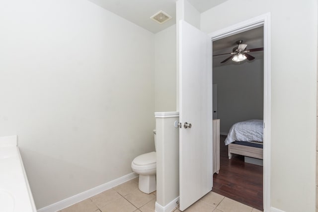 1803 Fallow Ln, Houston, TX 77049 - bathroom with toilet, tile patterned floors, ceiling fan, and baseboards