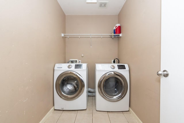 1803 Fallow Ln, Houston, TX 77049 - laundry area featuring independent washer and dryer, light tile patterned flooring, and baseboards
