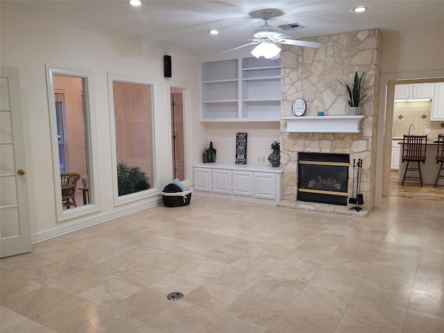 2626 Blue Lake Dr, Magnolia, TX 77354 - unfurnished living room featuring a ceiling fan, a fireplace, built in features, recessed lighting, and ornamental molding