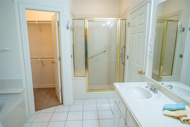 2626 Blue Lake Dr, Magnolia, TX 77354 - full bath featuring tile patterned floors, a stall shower, a walk in closet, and vanity