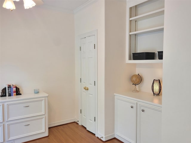 2626 Blue Lake Dr, Magnolia, TX 77354 - hallway featuring light wood finished floors, crown molding, and baseboards