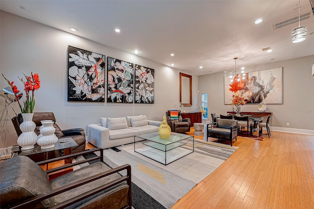 536 Rutland Pl, Houston, TX 77007 - living room featuring recessed lighting, wood finished floors, baseboards, and a chandelier