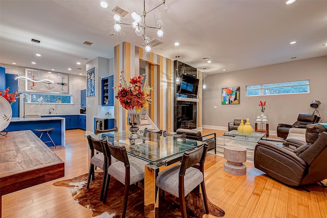 536 Rutland Pl, Houston, TX 77007 - dining area featuring light wood finished floors, recessed lighting, a large fireplace, and baseboards