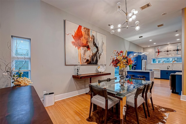 536 Rutland Pl, Houston, TX 77007 - dining room with light wood-type flooring, a chandelier, baseboards, and recessed lighting