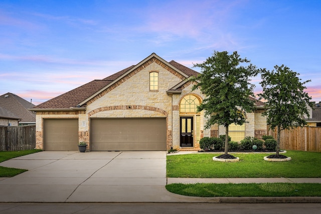 12510 Sherborne Castle Ct, Tomball, TX 77375 - french country home with driveway, a garage, a shingled roof, stone siding, and brick siding
