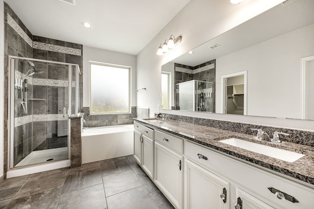 12510 Sherborne Castle Ct, Tomball, TX 77375 - bathroom with a stall shower, double vanity, a garden tub, a spacious closet, and recessed lighting