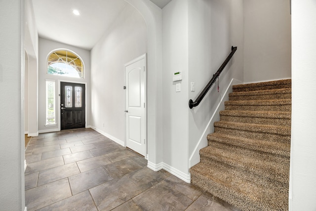 12510 Sherborne Castle Ct, Tomball, TX 77375 - entryway featuring arched walkways, stairway, and baseboards