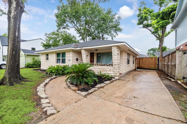 1219 Candlelight Ln, Houston, TX 77018 - view of front of house featuring stone siding and concrete driveway