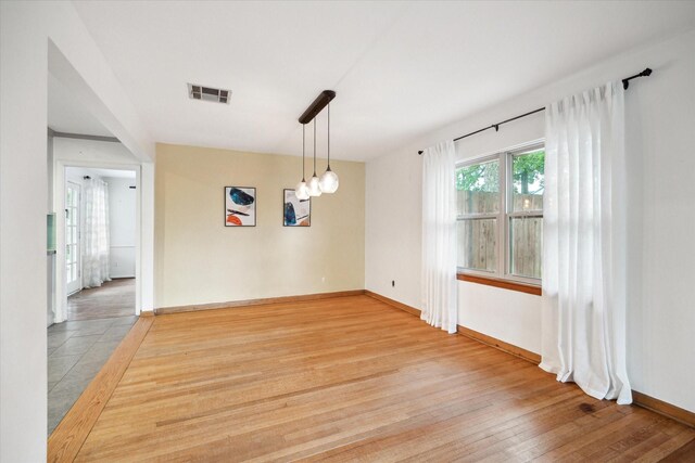 1219 Candlelight Ln, Houston, TX 77018 - unfurnished dining area with light wood-style flooring and baseboards
