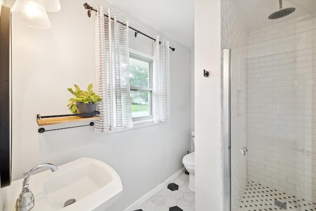 1219 Candlelight Ln, Houston, TX 77018 - full bathroom featuring a shower stall, a sink, toilet, tile patterned flooring, and baseboards