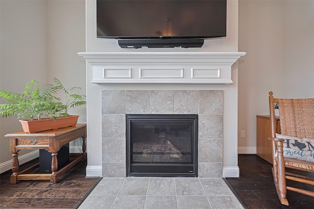 18526 Waterfall Creek Way, Cypress, TX 77429 - detailed view of a fireplace, wood finished floors, and baseboards