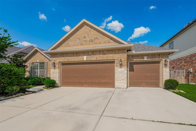 18526 Waterfall Creek Way, Cypress, TX 77429 - view of front of home with brick siding, an attached garage, driveway, and a shingled roof