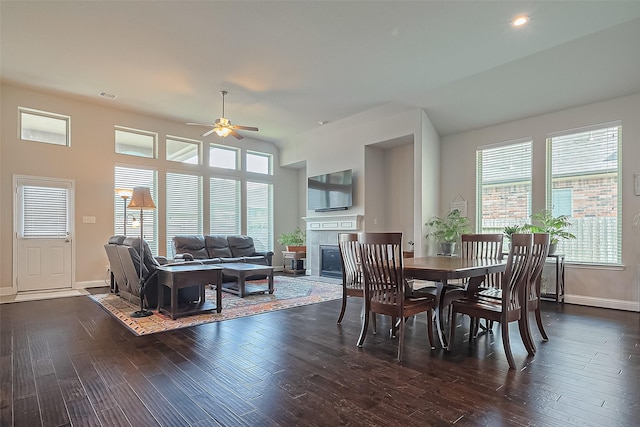 18526 Waterfall Creek Way, Cypress, TX 77429 - dining space with ceiling fan, dark wood-style flooring, baseboards, a glass covered fireplace, and recessed lighting