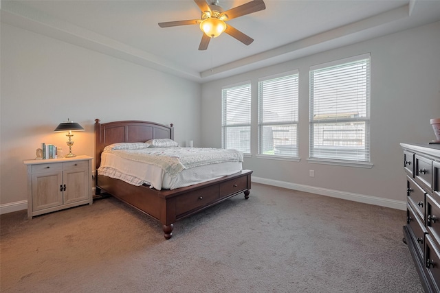18526 Waterfall Creek Way, Cypress, TX 77429 - bedroom with light colored carpet, baseboards, a raised ceiling, and a ceiling fan