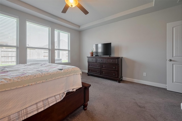18526 Waterfall Creek Way, Cypress, TX 77429 - bedroom with light colored carpet, baseboards, a tray ceiling, and ceiling fan