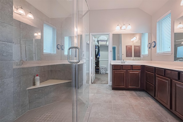 18526 Waterfall Creek Way, Cypress, TX 77429 - full bath with a shower stall, double vanity, plenty of natural light, vaulted ceiling, and a walk in closet