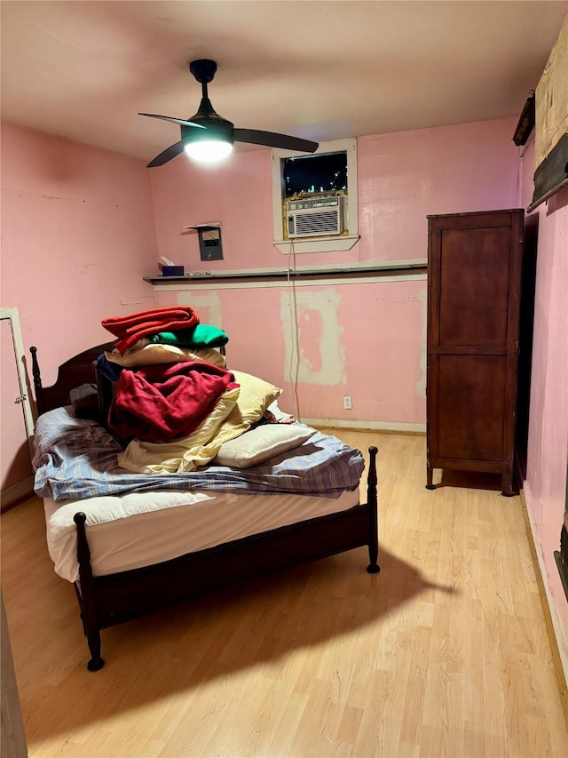 385 Ole Long Pull Rd, Livingston, TX 77351 - bedroom with light wood-style flooring, cooling unit, ceiling fan, and baseboards