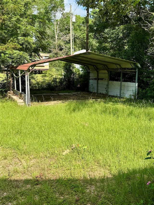 385 Ole Long Pull Rd, Livingston, TX 77351 - view of yard featuring a carport