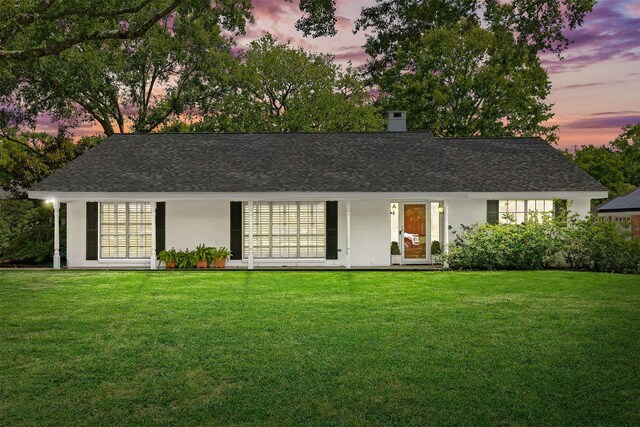 1908 Oak Shadows St, Baytown, TX 77520 - view of front of house with a front lawn, a chimney, a shingled roof, and brick siding