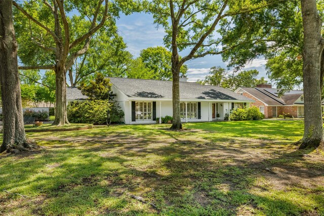 1908 Oak Shadows St, Baytown, TX 77520 - ranch-style house with a front lawn and french doors
